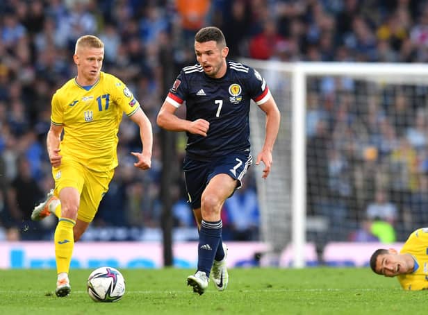 John McGinn is challenged by Oleksandr Zinchenko during the FIFA World Cup Qualifier at Hampden Park on June 01, 2022 in Glasgow, Scotland. (Photo by Mark Runnacles/Getty Images)