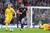 John McGinn is challenged by Oleksandr Zinchenko during the FIFA World Cup Qualifier at Hampden Park on June 01, 2022 in Glasgow, Scotland. (Photo by Mark Runnacles/Getty Images)