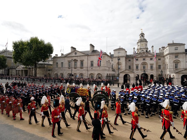The State Gun Carriage carries the coffin of Queen Elizabeth II, draped in the Royal Standard with the Imperial State Crown and the Sovereign's orb and sceptre, in the Ceremonial Procession following her State Funeral at Westminster Abbey, London. Picture date: Monday September 19, 2022.