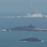 A Chinese ship takes part in military exercises northeast of Pingtan island, the closest point in China to Taiwan. Rising tensions could affect the global economy (Picture: Greg Baker/AFP via Getty Images)