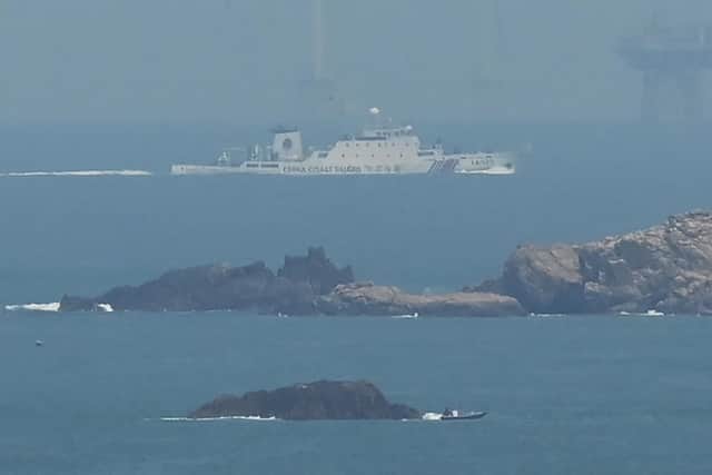 A Chinese ship takes part in military exercises northeast of Pingtan island, the closest point in China to Taiwan. Rising tensions could affect the global economy (Picture: Greg Baker/AFP via Getty Images)