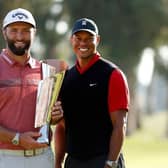 Jon Rahm with tournament host Tiger Woods after being presented with the trophy following his win in The Genesis Invitational at Riviera Country Club in Pacific Palisades, California. Picture: Cliff Hawkins/Getty Images.