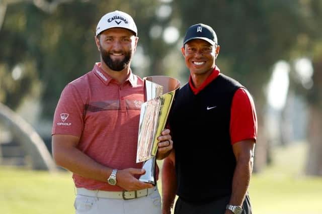 Jon Rahm with tournament host Tiger Woods after being presented with the trophy following his win in The Genesis Invitational at Riviera Country Club in Pacific Palisades, California. Picture: Cliff Hawkins/Getty Images.