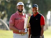 Jon Rahm with tournament host Tiger Woods after being presented with the trophy following his win in The Genesis Invitational at Riviera Country Club in Pacific Palisades, California. Picture: Cliff Hawkins/Getty Images.