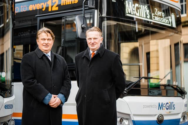 James and Sandy Easdale of McGill's Group with an electric bus.