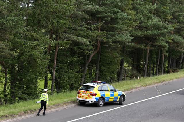 File photo dated 09/07/15 of police officers searching the scene at Junction 9 of the M9 near Stirling where John Yuill and Lamara Bell were discovered.