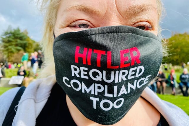 One protester demonstrating at the event was pictured wearing a mask saying 'Hitler required compliance too.'