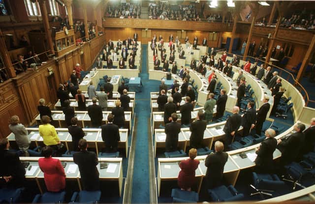 For the first time since 1707 the Scottish Parliament today reconvened in Edinburgh at its temporary home in the former Assembly Hall on The Mound, Edinburgh. MSPs are pictured standing before the start of the parliament's first business on May 12, 1999. PIC: David Cheskin.