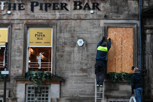 The Piper Bar in Glasgow being boarded up for lockdown picture: John Devlin/JPI Media