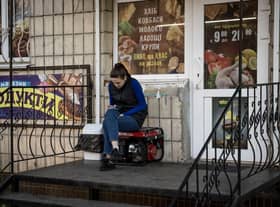 A woman sits on a generator outside a shop in Borodyanka in the Kyiv region, Ukraine. Picture: Getty Images