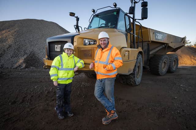 Jay Currie, 13, from Cullen, Moray, with his his father James, who has become one of the youngest trained articulated dump truck drivers after gaining his Construction Plant Competence Scheme. Picture: Paul Campbell/SPOA/PA Wire