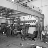 Workers with the wheel press in the wheelwrights workshop in the St Rollox Locomotive Works in Springburn, Glasgow
Pic: HES