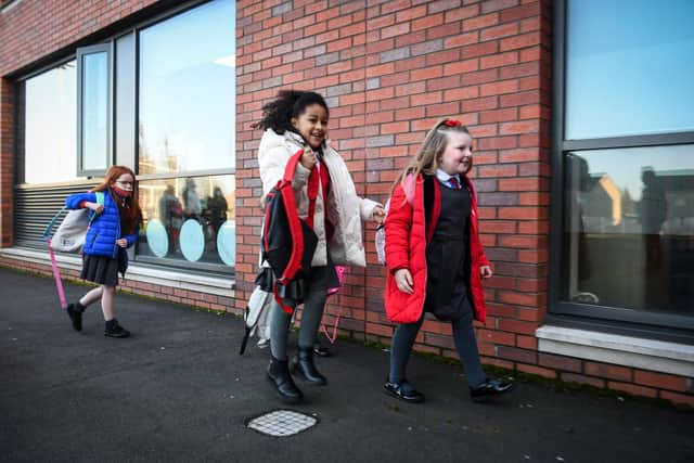 Pupils arrive at Clyde Primary School in Glasgow on February 22, 2021 as schools in Scotland started to reopen to more of the youngest students in an easing of the coronavirus shutdown. (Photo by Andy Buchanan / AFP) (Photo by ANDY BUCHANAN/AFP via Getty Images)
