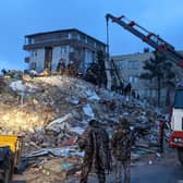 Rescue workers and volunteers search for survivors in the rubble of a collasped building, in Sanliurfa, Turkey, on February 6, 2023, after a 7.8-magnitude earthquake struck the country's south-east. - The combined death toll has risen to over 2,300 for Turkey and Syria after the region's strongest quake in nearly a century. Turkey's emergency services said at least 1,121 people died in the earthquake, with another 783 confirmed fatalities in Syria. (Photo by REMI BANET / AFP) (Photo by REMI BANET/AFP via Getty Images)