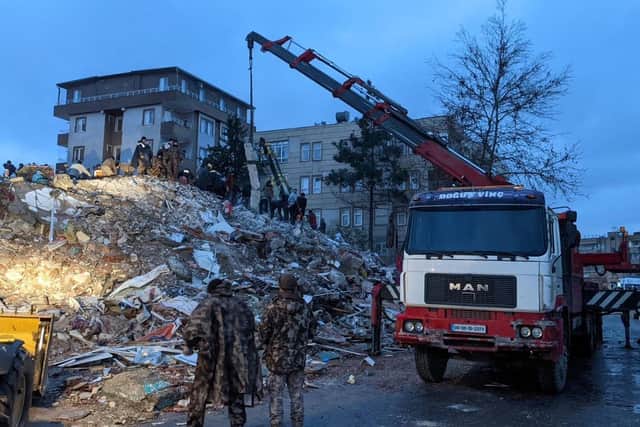 Rescue workers and volunteers search for survivors in the rubble of a collasped building, in Sanliurfa, Turkey, on February 6, 2023, after a 7.8-magnitude earthquake struck the country's south-east. - The combined death toll has risen to over 2,300 for Turkey and Syria after the region's strongest quake in nearly a century. Turkey's emergency services said at least 1,121 people died in the earthquake, with another 783 confirmed fatalities in Syria. (Photo by REMI BANET / AFP) (Photo by REMI BANET/AFP via Getty Images)