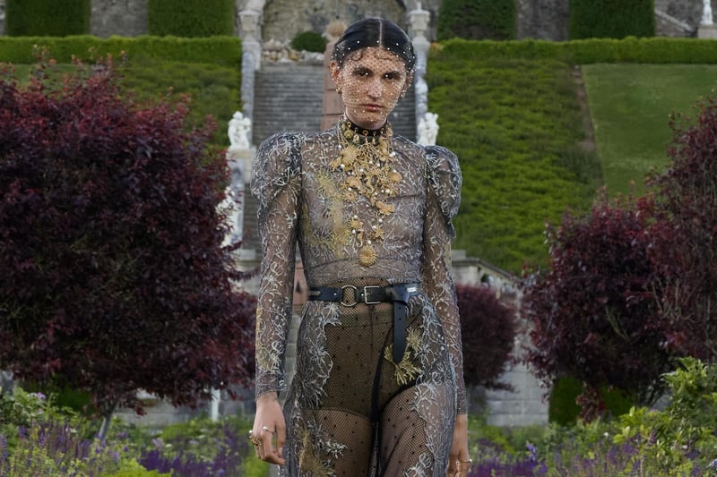 A heavily embellished and appliqued floor length transparent dress with leather belt.