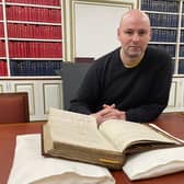 Manuscripts curator Ralph McLean with Sir Walter Scott's original working manuscript of Rob Roy.