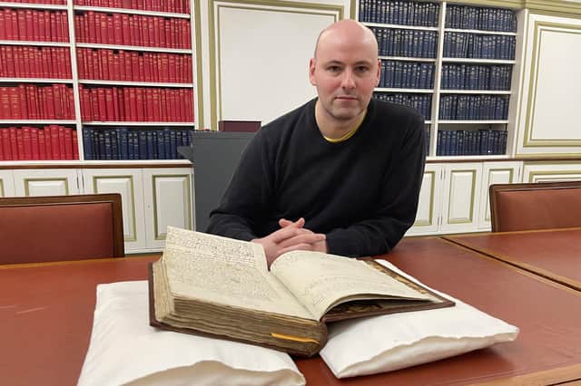 Manuscripts curator Ralph McLean with Sir Walter Scott's original working manuscript of Rob Roy.