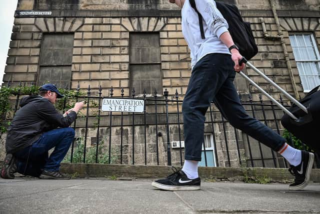 Members of the public walk past a Black Lives Matter street sign in Edinburgh in June 2020. Activists hung alternative street signs on several streets and buildings with ties to Scotland’s slave trade around the city