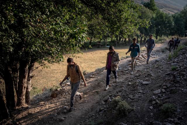 Afghan migrants walk along a path to reach Tatvan city in Turkey after President Joe Biden announced US troops would withdraw from Afghanistan (Picture: Chris McGrath/Getty Images)