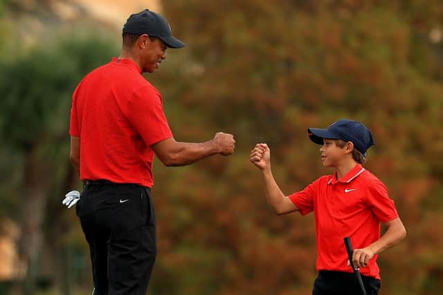 Tiger Woods and son Charlie Woods fist bump during the PNC Championship at the Ritz Carlton Golf Club in Orlando, Florida on 20 Deember. Woods undewent his latest back surgery three days later. Picture: Mike Ehrmann/Getty Images.