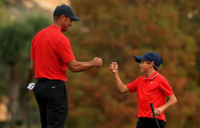 Tiger Woods and son Charlie Woods fist bump during the PNC Championship at the Ritz Carlton Golf Club in Orlando, Florida on 20 Deember. Woods undewent his latest back surgery three days later. Picture: Mike Ehrmann/Getty Images.