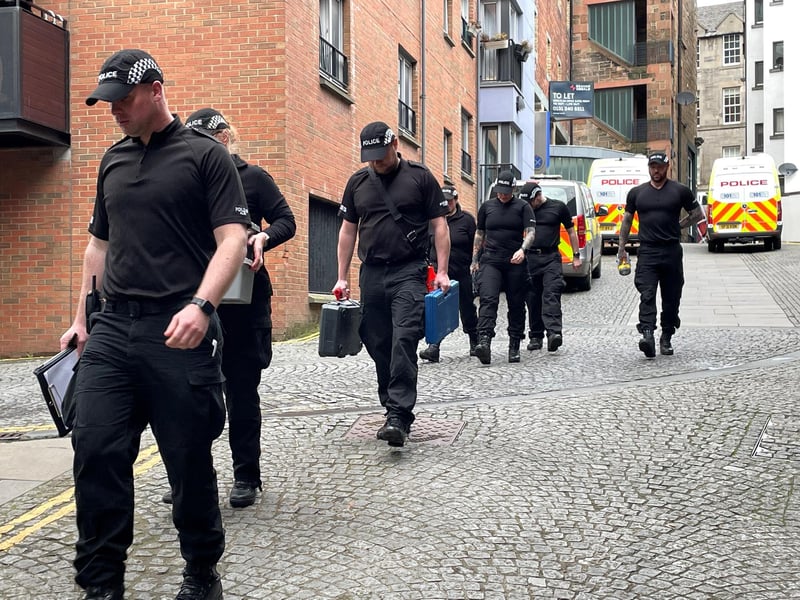 Outside the SNP office in the Scottish Capital, officers are stood guard in the entrance and others have been entering and leaving the building.