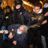 Police officers detain a demonstrator during a protest against Russia's invasion of Ukraine in central Saint Petersburg (Picture: Sergei Mikhailichenko/AFP via Getty Images)