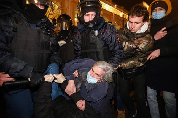 Police officers detain a demonstrator during a protest against Russia's invasion of Ukraine in central Saint Petersburg (Picture: Sergei Mikhailichenko/AFP via Getty Images)