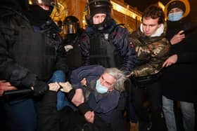 Police officers detain a demonstrator during a protest against Russia's invasion of Ukraine in central Saint Petersburg (Picture: Sergei Mikhailichenko/AFP via Getty Images)
