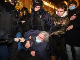 Police officers detain a demonstrator during a protest against Russia's invasion of Ukraine in central Saint Petersburg (Picture: Sergei Mikhailichenko/AFP via Getty Images)