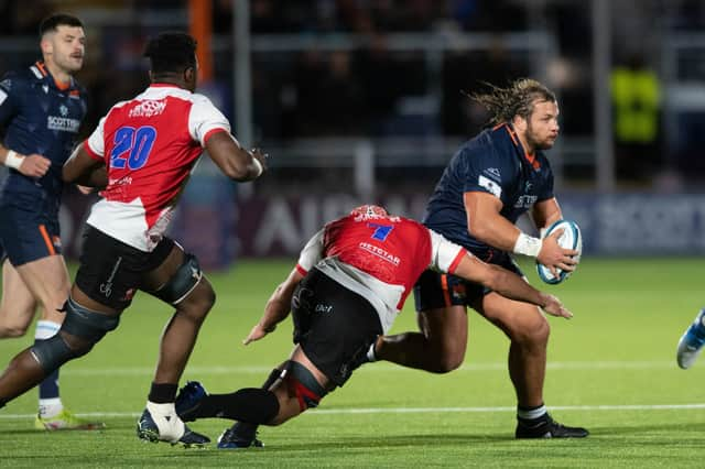 Edinburgh's Pierre Schoeman is tackled by Lions' Sti Sithole during the 22-19 defeat by the South Africans.