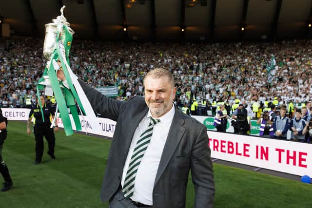 Ange Postecoglou celebrates in front of the Celtic supporters with the Scottish Cup.