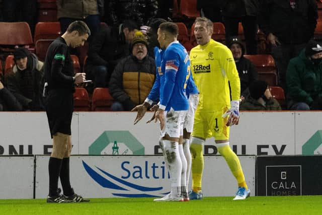 Rangers players argue with Kevin Clancy during the draw with the Dons.