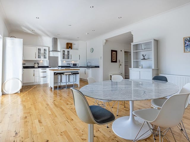Interior: An open-plan kitchen and dining room benefits from French doors opening to the rear garden. The ground floor includes a lounge, bathroom and two bedrooms. Upstairs are another three and a box room.