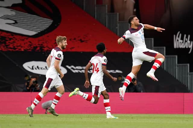 Che Adams of Southampton (right) celebrates with Kyle Walker-Peters and Stuart Armstrong (Photo by Will Oliver/Pool via Getty Images)