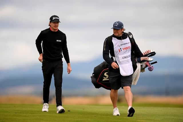 Sean Crocker walks with his caddie during the third round of the Hero Open at Fairmont St Andrews. Picture: Ross Kinnaird/Getty Images.