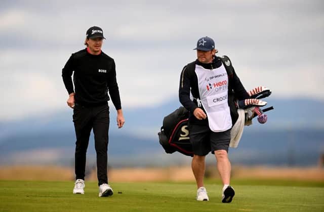 Sean Crocker walks with his caddie during the third round of the Hero Open at Fairmont St Andrews. Picture: Ross Kinnaird/Getty Images.
