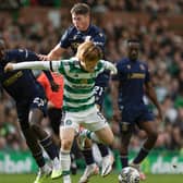 Celtic's Kyogo Furuhashi fends off two of Dundee's young midfielders Malachi Boeteng (left) and Ryan Howley, 20 and 19-years-old respectively.  (Photo by Craig Foy / SNS Group)