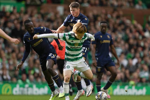 Celtic's Kyogo Furuhashi fends off two of Dundee's young midfielders Malachi Boeteng (left) and Ryan Howley, 20 and 19-years-old respectively.  (Photo by Craig Foy / SNS Group)