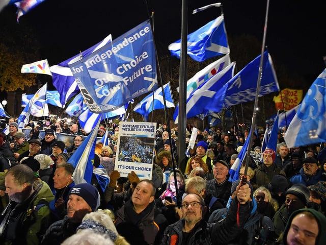 Pro-Scottish independence supporters wave Saltire flags during a rally outside parliament in Edinburgh on November 23, 2022 after the UK Supreme Court rejected Scottish independence vote plans.