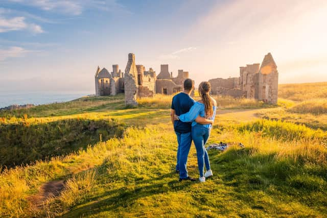 A couple survey Slains Castle in Aberdeenshire. Picture: VisitScotland