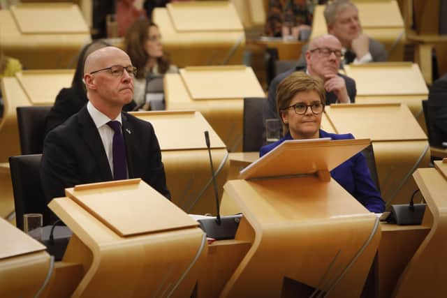 Deputy First Minister and temporary Cabinet Secretary for Finance and Economy, John Swinney MSP, sat next to First Minister of Scotland Nicola Sturgeon, as he delivers the Scottish Budget to the Scottish Parliament in Edinburgh.