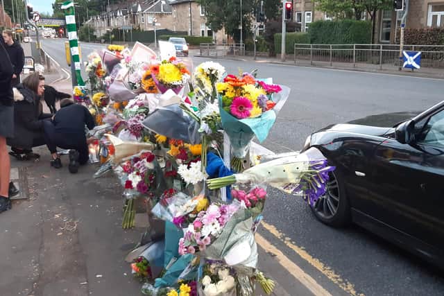 Friends laid tributes to Aidan Pilkington on Crow Road on Sunday. Picture: The Scotsman