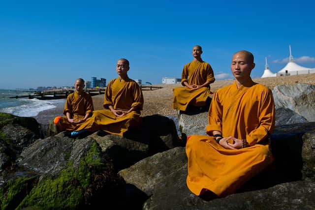 Shaolin monks meditate on a beach at Bognor Regis, England, in 2015 (Picture: Ben Pruchnie/Getty Images)