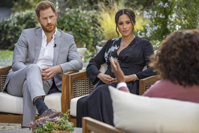 This image provided by Harpo Productions shows Prince Harry, from left, and Meghan, The Duchess of Sussex, in conversation with Oprah Winfrey. Joe Pugliese/Harpo Productions via AP