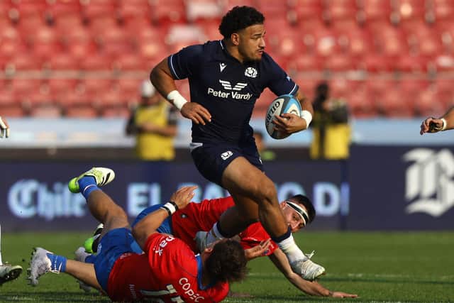 Scotland's centre Sione Tuipulotu leaves two Chile players in his wake during the 52-11 victory in Santiago, on July 20, 2024. (Photo by JAVIER TORRES/AFP via Getty Images)