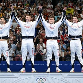 Gold medallists James Guy, Tom Dean, Matthew Richards and Duncan Scott celebrate on the podium after the men's 4x200m freestyle relay swimming final. (Photo by SEBASTIEN BOZON/AFP via Getty Images)