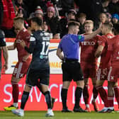 Aberdeen's Ross McCrorie (centre) appeals to referee Grant Irvine after he is sent off following a VAR check. (Photo by Ross Parker / SNS Group)