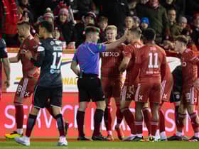 Aberdeen's Ross McCrorie (centre) appeals to referee Grant Irvine after he is sent off following a VAR check. (Photo by Ross Parker / SNS Group)